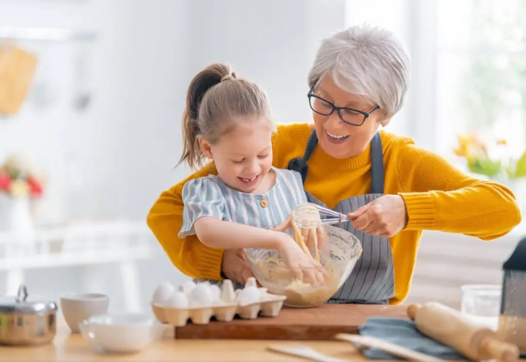 senior woman baking with her granddaughter