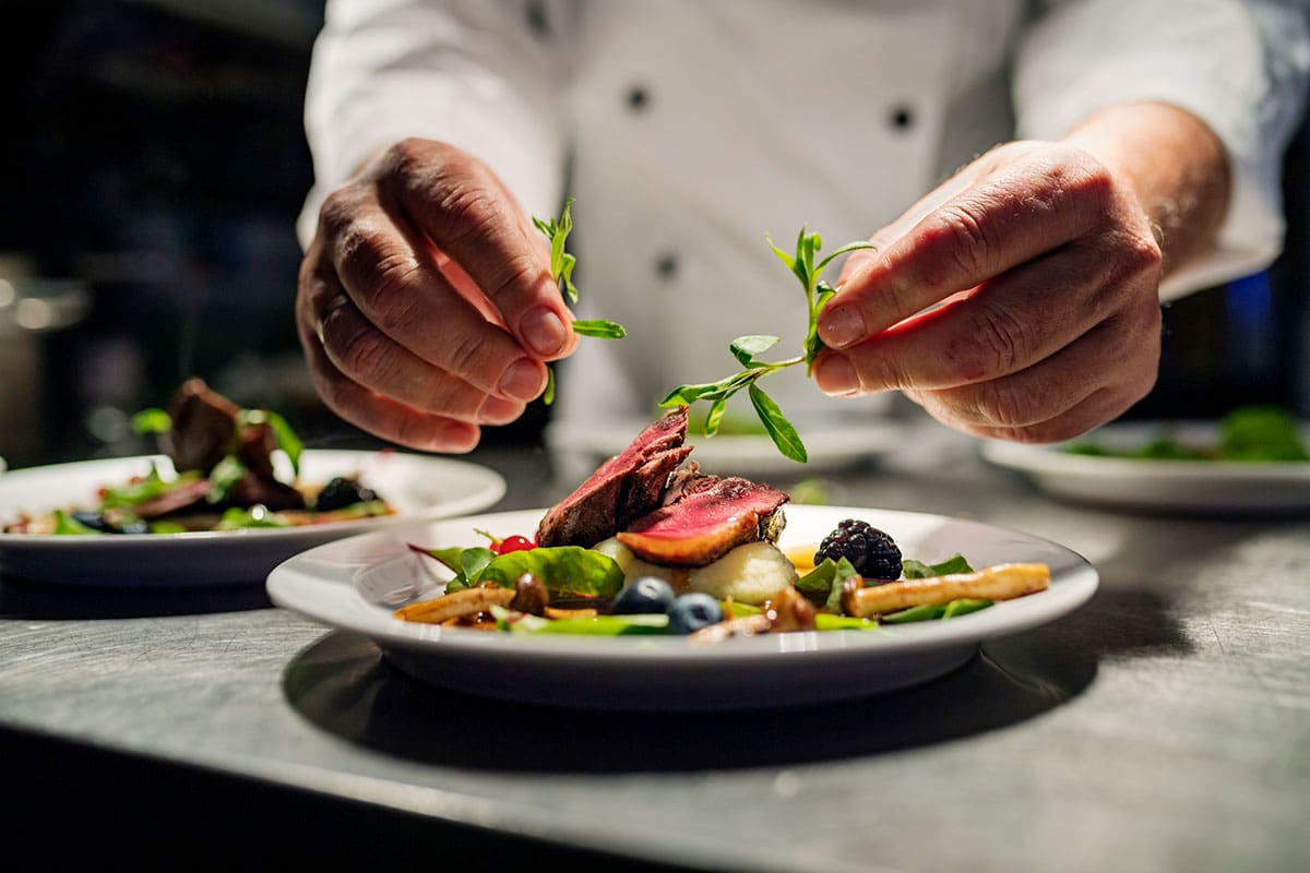 chef preparing a fine dining plate of food