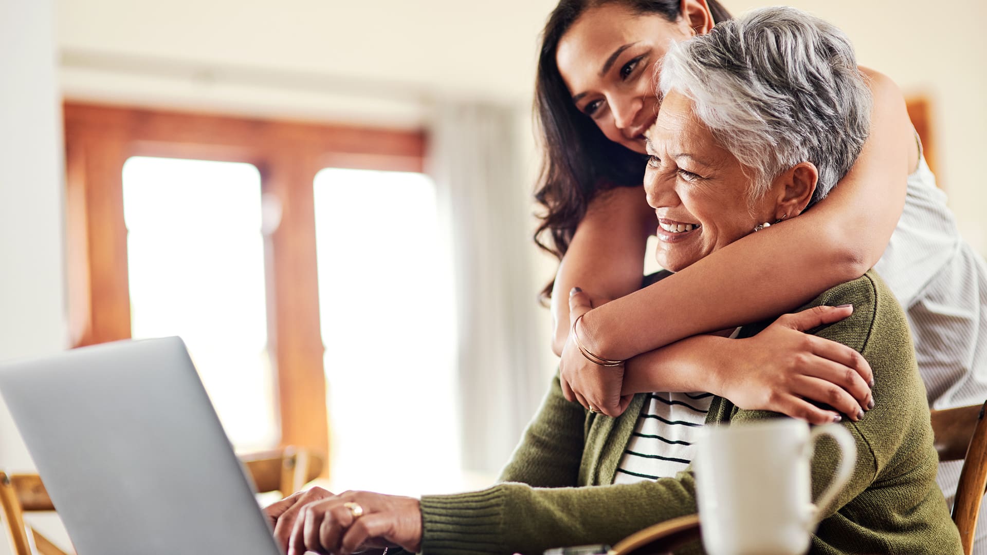 senior at a computer with her daughter