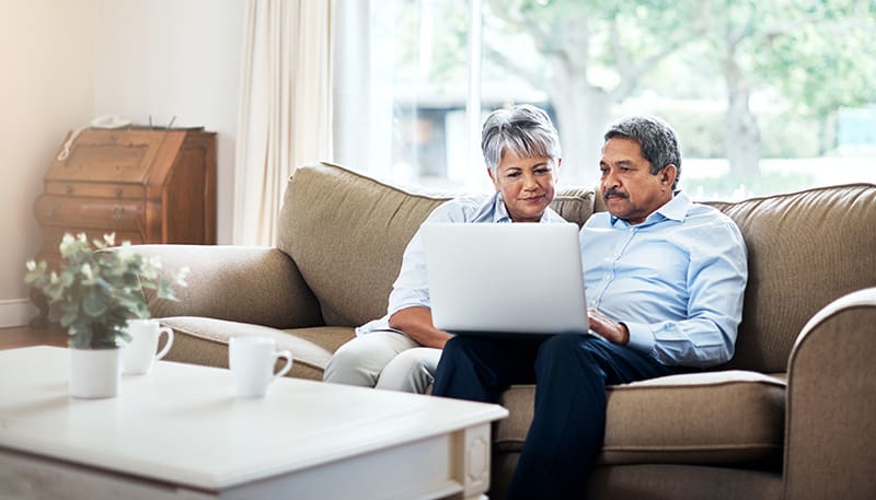 Shot of a senior couple using a laptop together at home