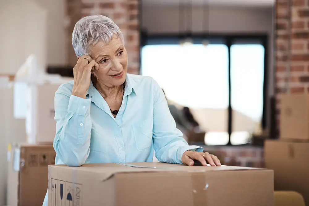 Shot of a senior woman looking unhappy while moving house